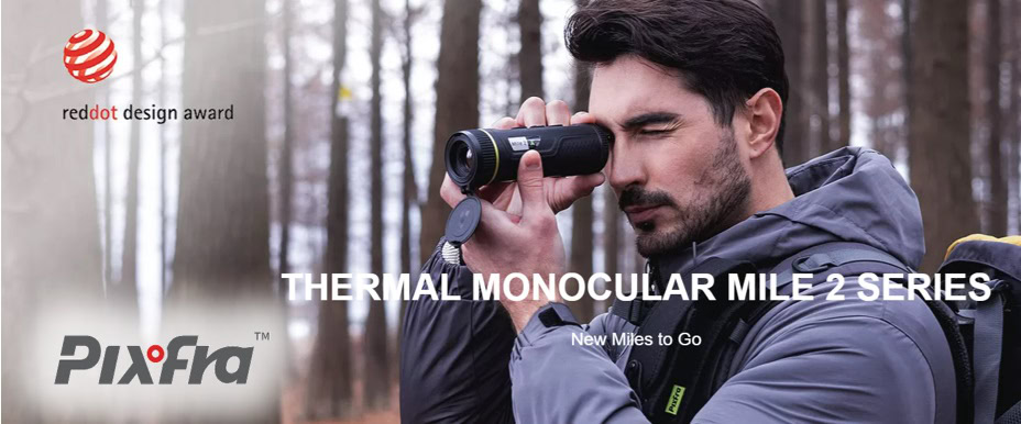 Pixfra-Mile2-lampokamera | Suomen Erämetsästys Man in a blue jacket uses binoculars in a forest; banner reads 'THERMAL MONOCULAR MILE 2 SERIES' with Red Dot Design Award logo at left.